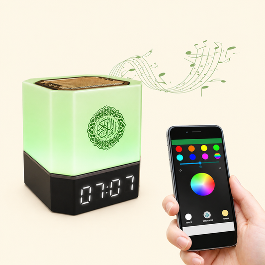 Green electronic device with digital clock display and Quranic Speaker, held by a hand with a smartphone showing color selection app.