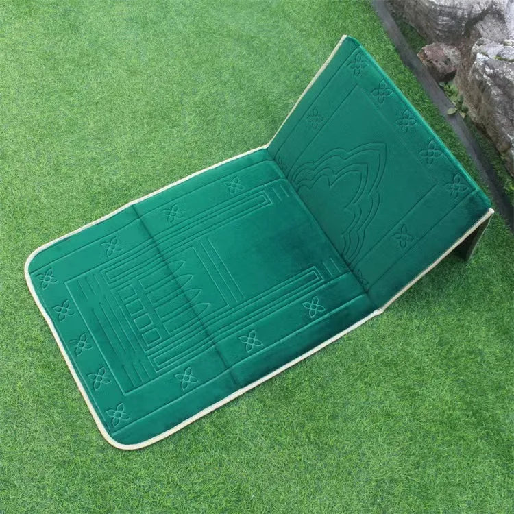 Green soft memory foam Islamic Prayer mat with back rest and  embossed patterns on a grassy surface