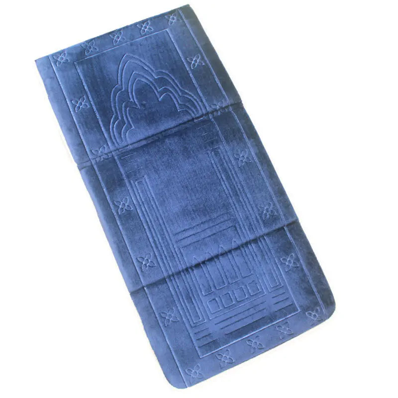 Blue soft memory foam Islamic Prayer mat with back rest and  embossed patterns on a white background