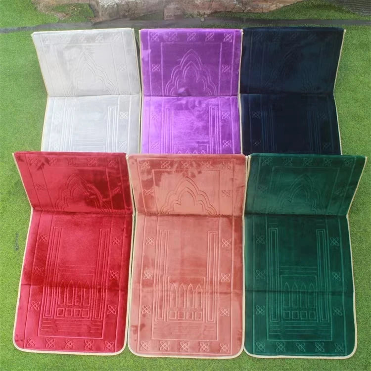 Set of six Islamic prayer mats with back rest in different colors on a grassy background