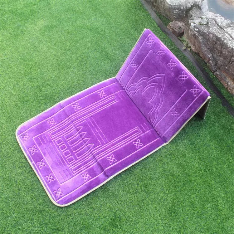 Purple soft memory foam Islamic prayer mat with back rest geometric patterns on a green grass background