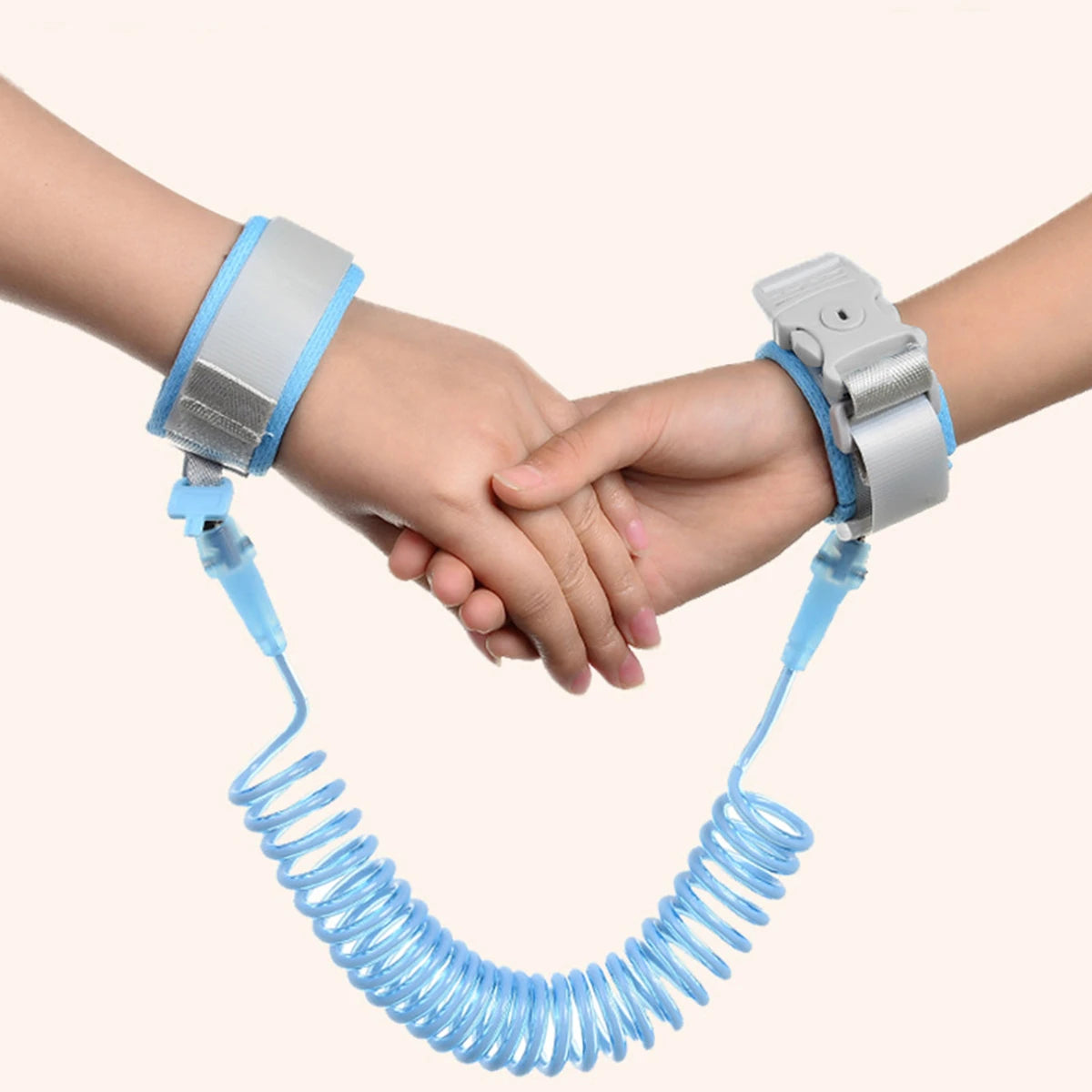 Two hands holding hands with a blue safety leash on a white background