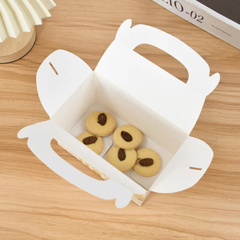 White cookie box with cookies on a wooden surface