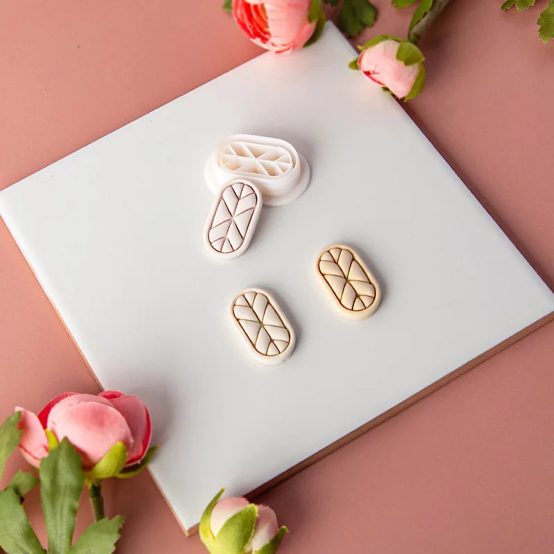 Wooden clay mold on a white box with pink flowers around