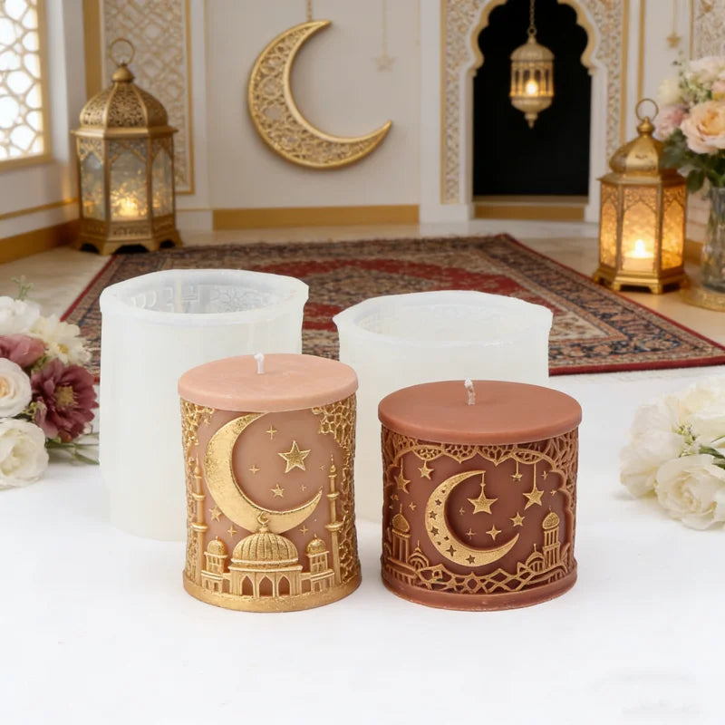 Decorative candles with moon and star designs on a table with a decorated room in the background.