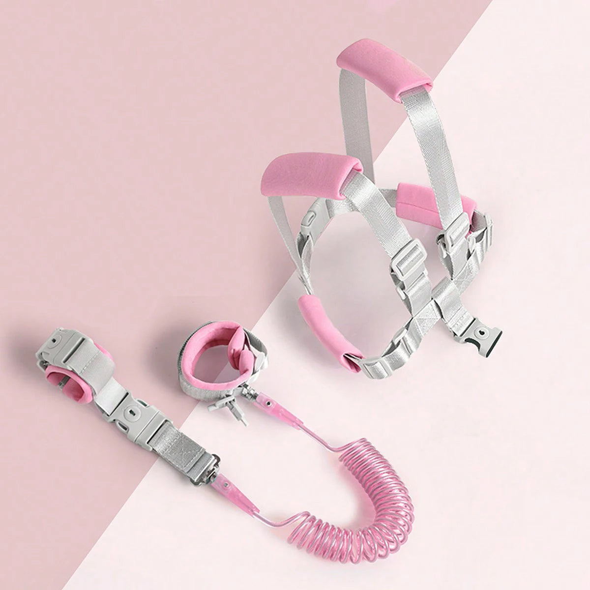 Pink and silver child leash on a pink and white background for safety during hajj and umrah pilgrimage 