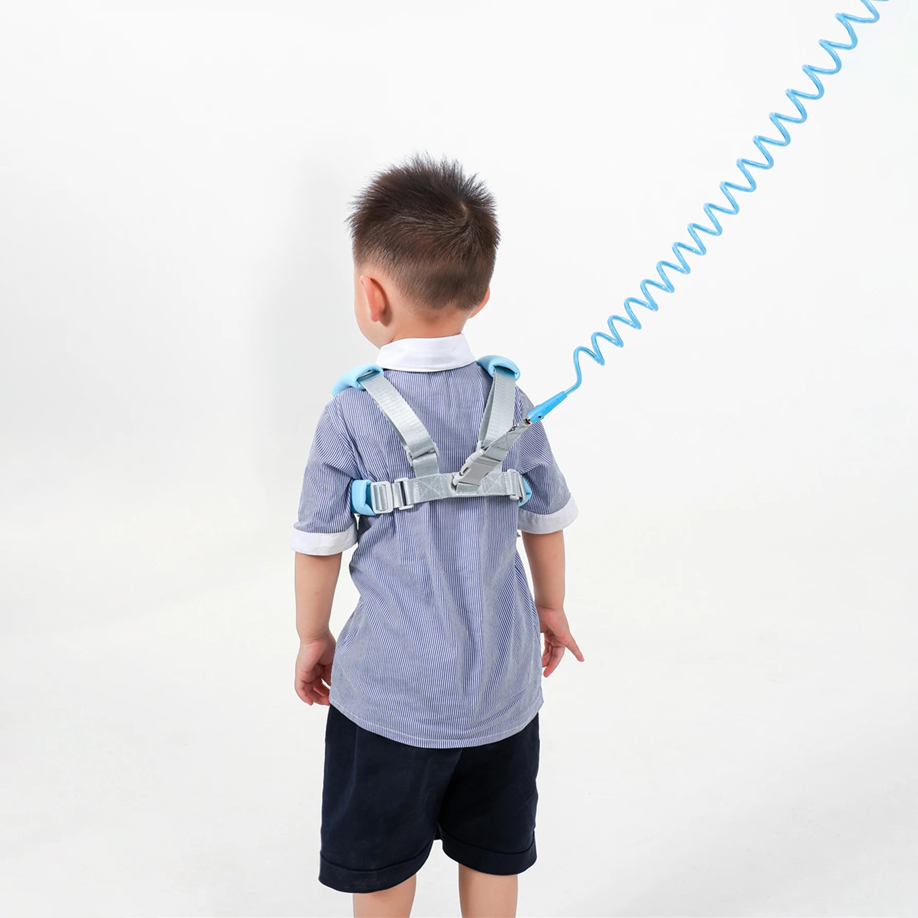 Child wearing a blue and gray back brace for hajj and umrah pilgrimage on a white background