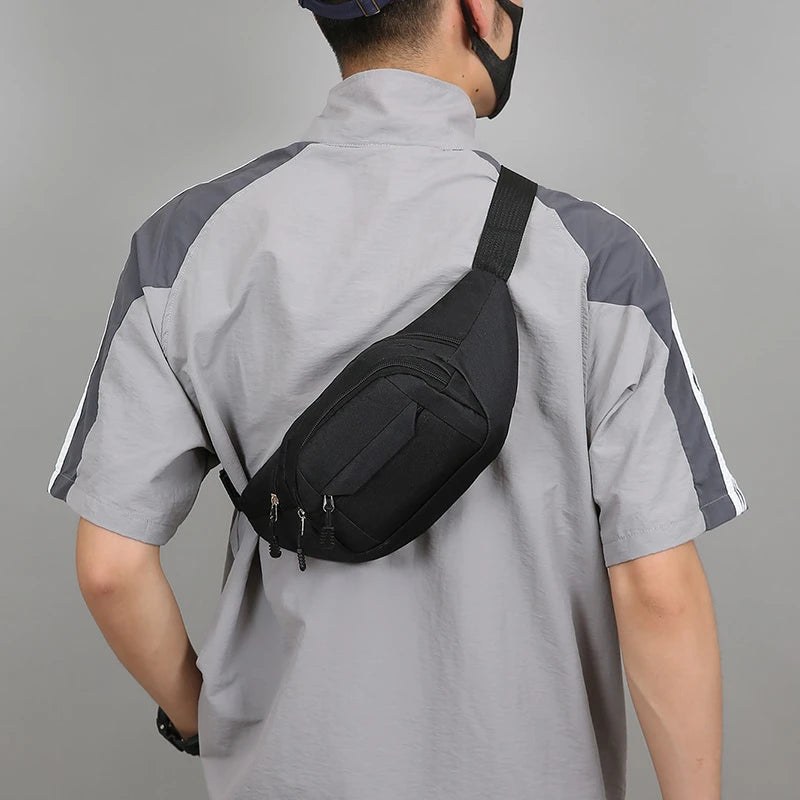 Person wearing a gray and black shirt with a black sling bag for hajj and umrah pilgrimage on a gray background