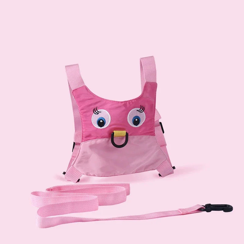 Pink children's harness with cartoon face design for hajj and umrah pilgrimage on a pink background