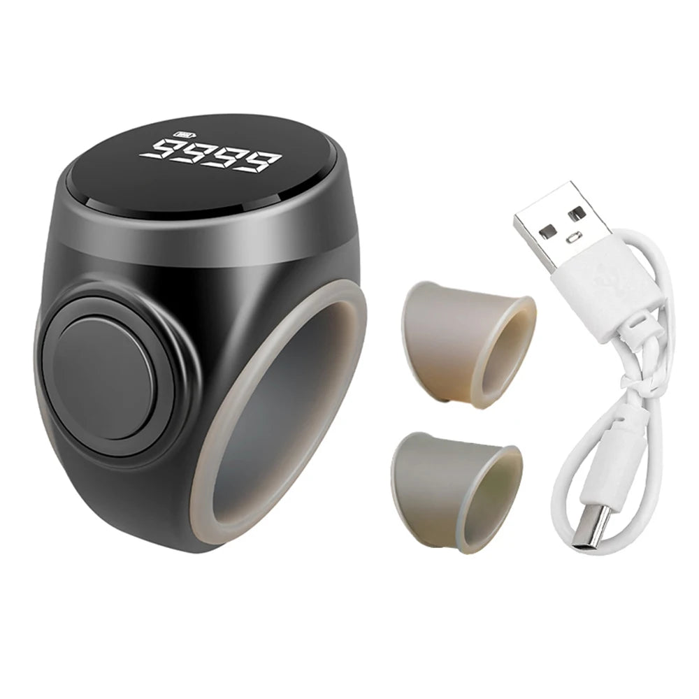 Black electronic tasbih zikr rings device with beige attachments and a USB cable on a white background