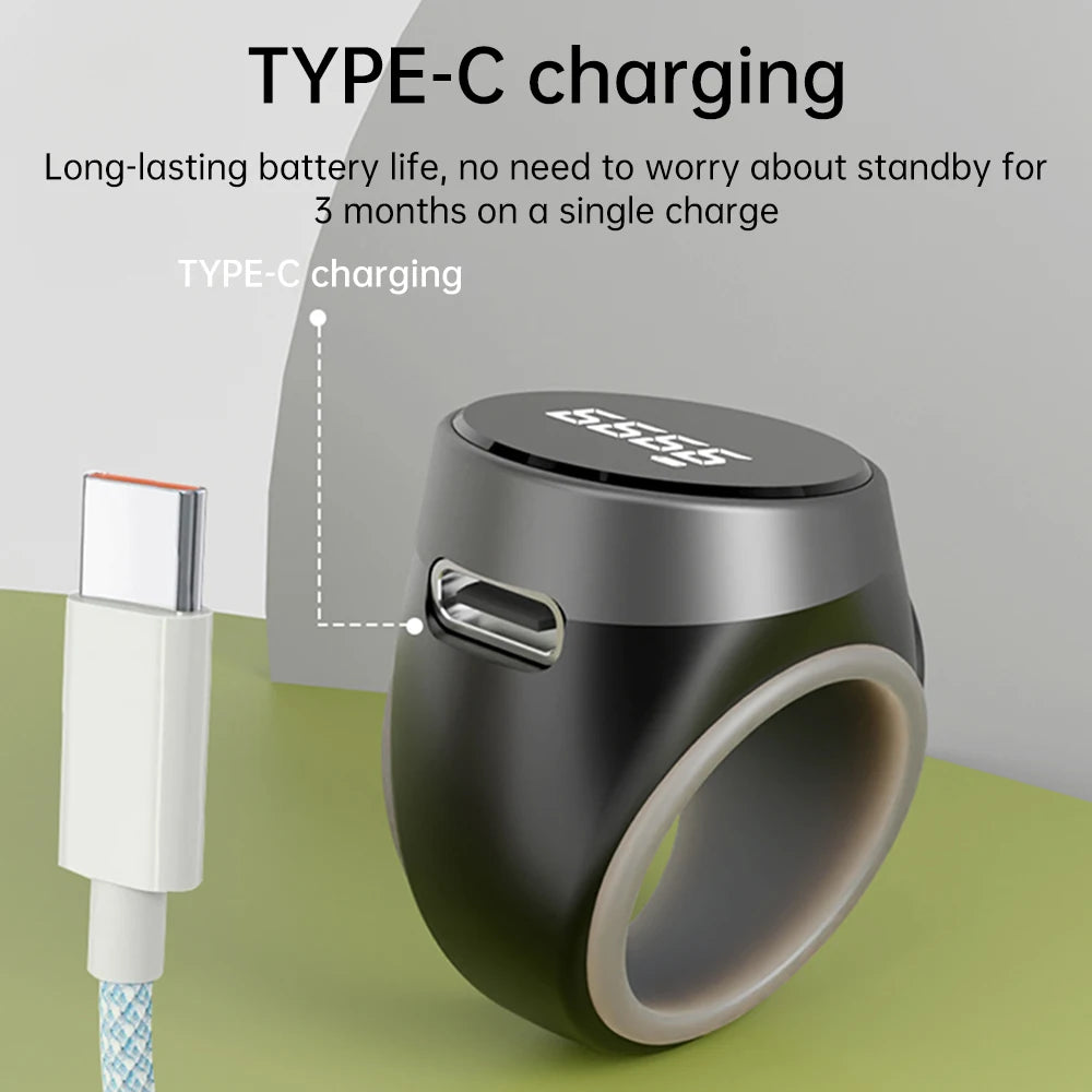 Black tasbih zikr ring-shaped device with USB-C cable on a green and gray background