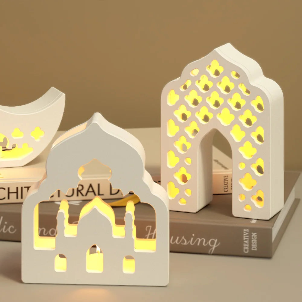 Decorative white arch-shaped lamps with a warm glow on a bookshelf.
