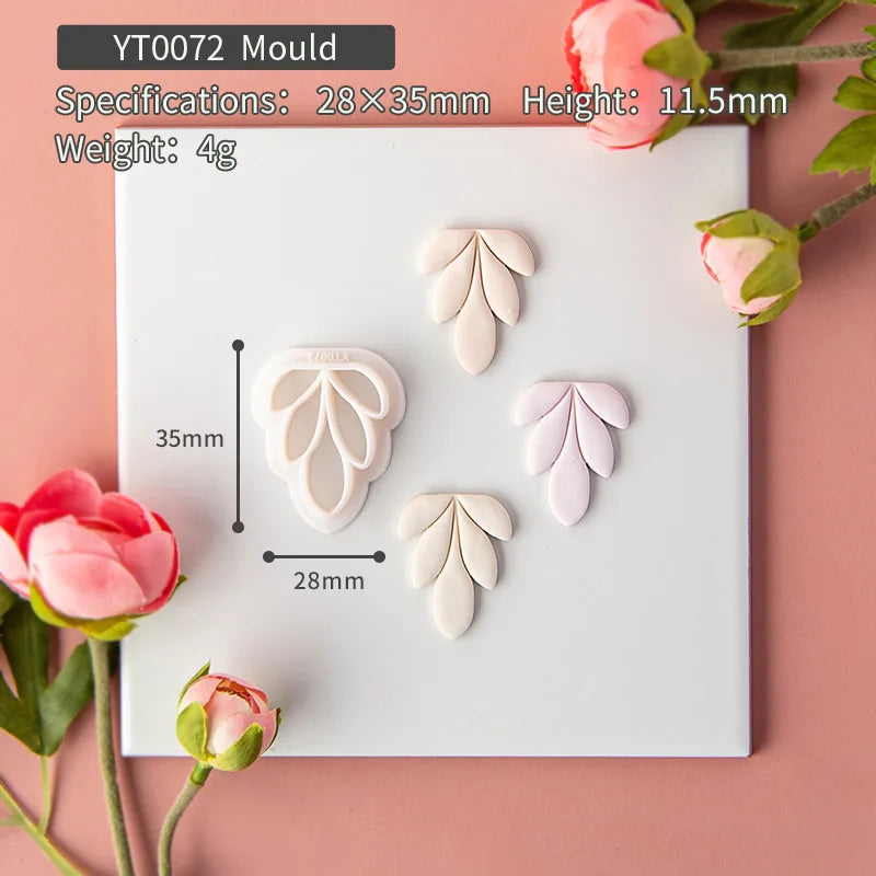Decorative leaf-shaped mold on a pink background with floral elements