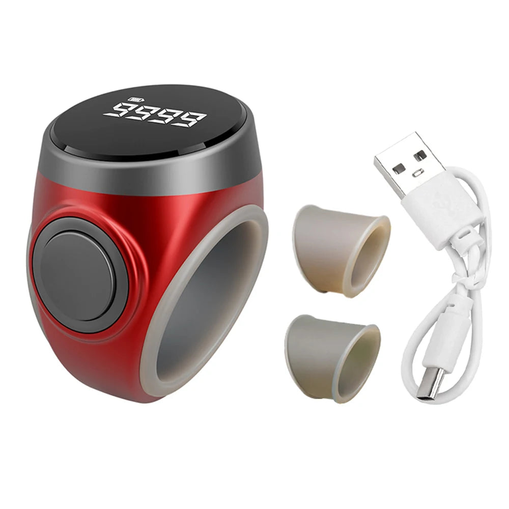 Red and gray electronic tasbih zikr ring device with digital display, two beige nozzles, and a USB cable on a white background.