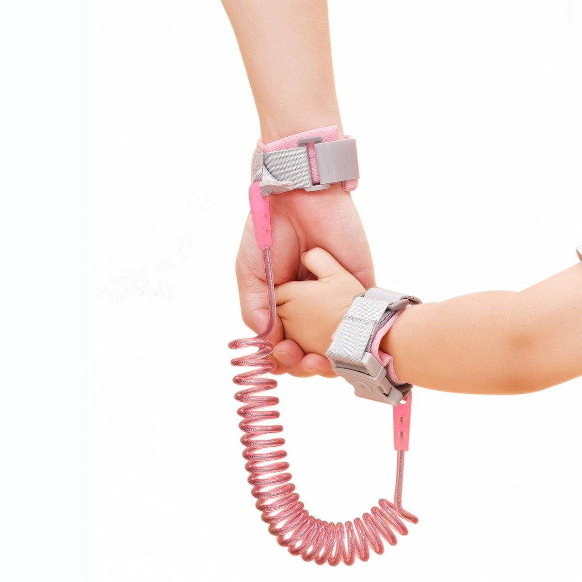 Pink and gray kids safety wrist leash being held by a hand on a white background